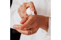 Image Pumping a foam skincare onto the backside of a hand.